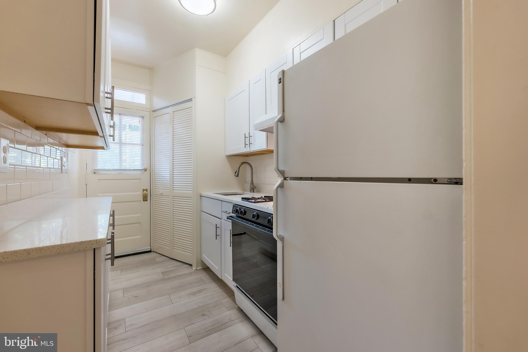 2341 40th Street Northwest, Unit 4 Washington, DC 20007 - Photo 6 of 21 a kitchen with a refrigerator stove and a sink