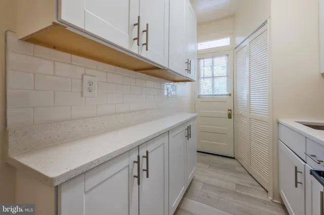 a utility room with cabinets washer and dryer