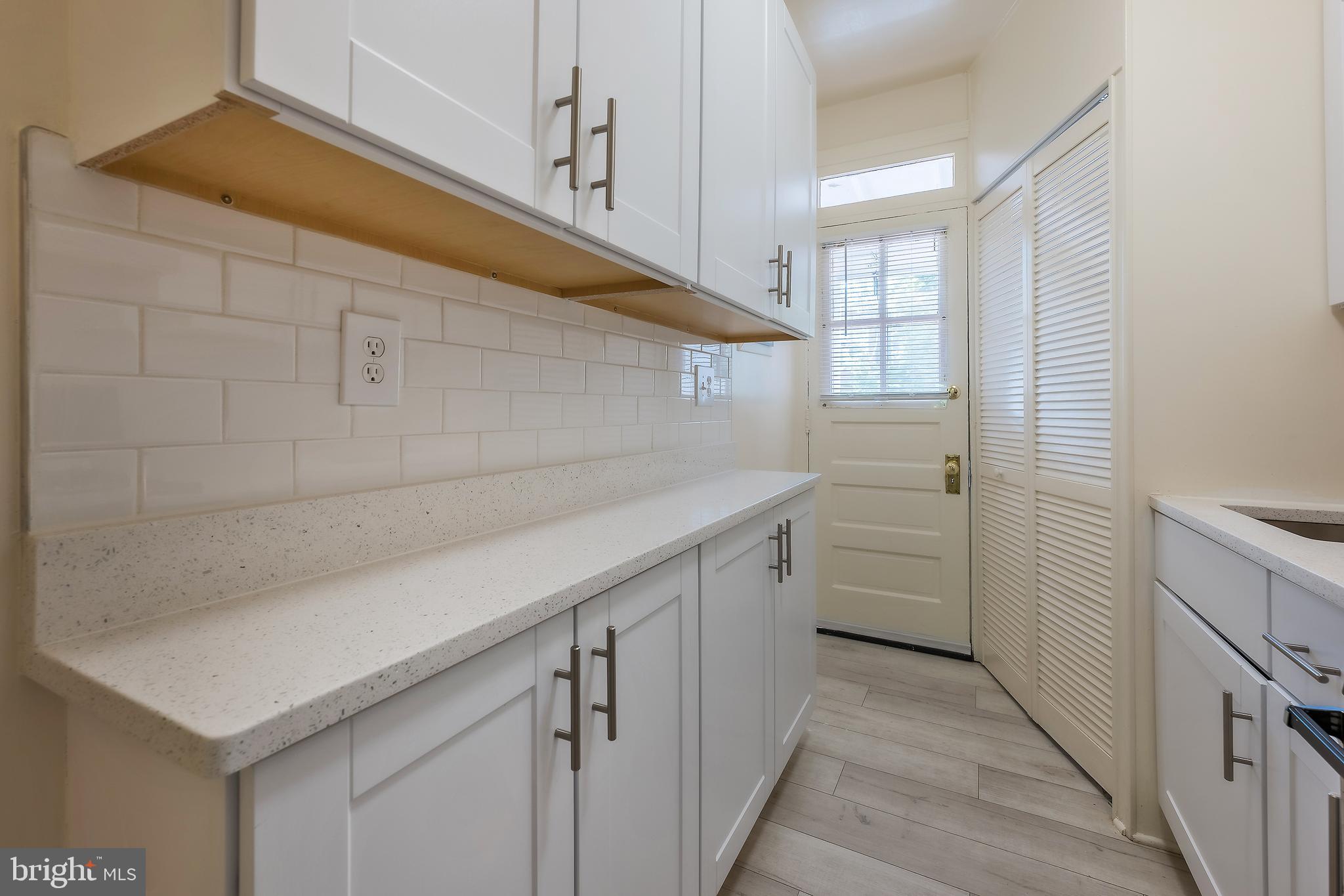 2341 40th Street Northwest, Unit 4 Washington, DC 20007 - Photo 7 of 21 a utility room with cabinets washer and dryer