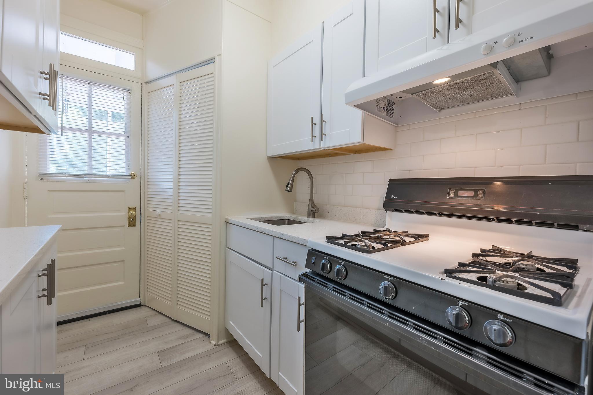 2341 40th Street Northwest, Unit 4 Washington, DC 20007 - Photo 8 of 21 a kitchen with a stove and a cabinets