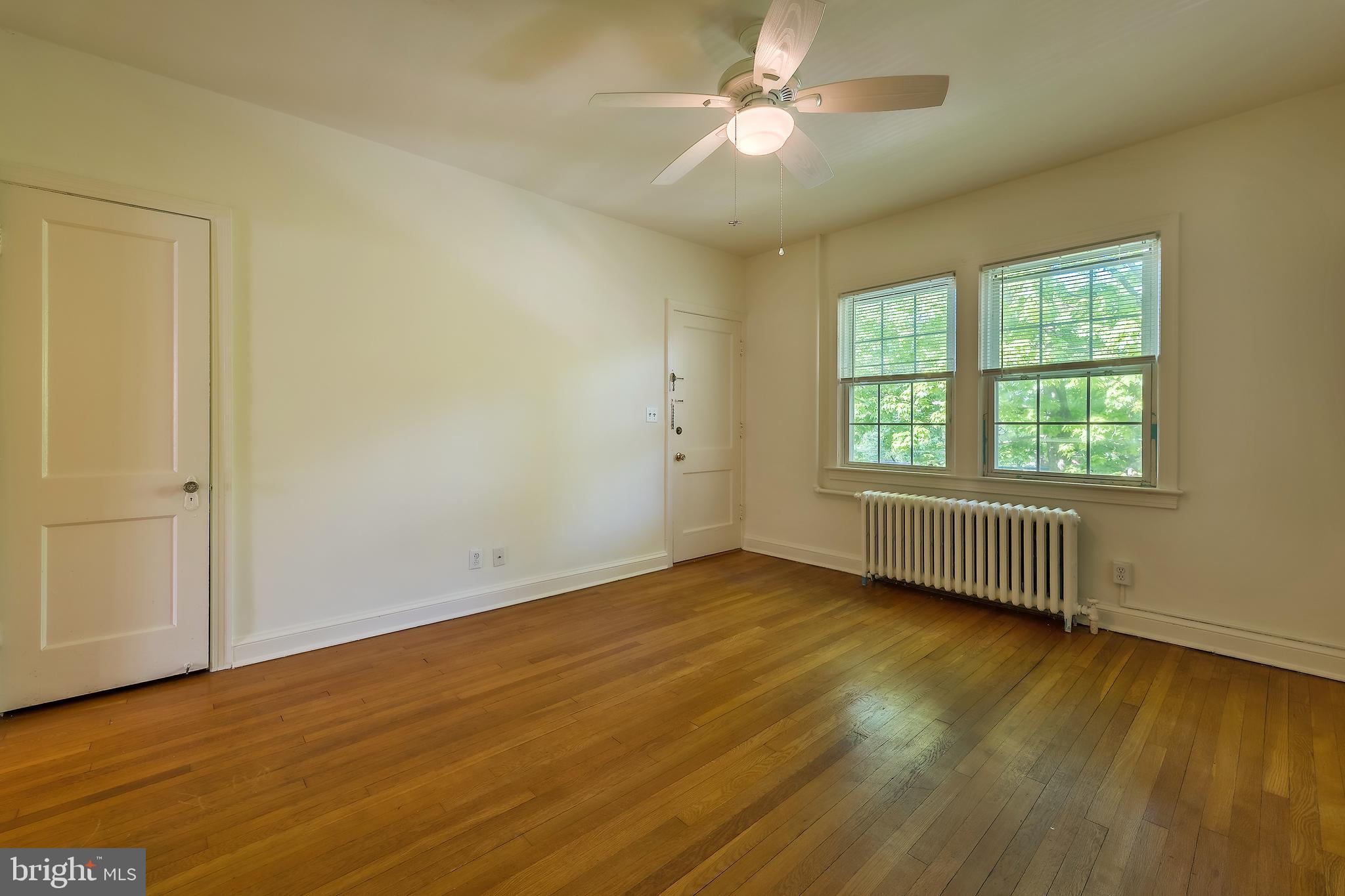 2341 40th Street Northwest, Unit 4 Washington, DC 20007 - Photo 10 of 21 a view of an empty room with wooden floor and a window