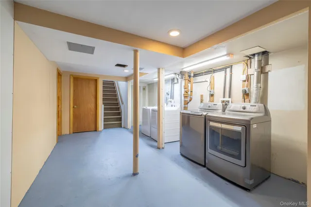 a view of a kitchen with refrigerator and white cabinets