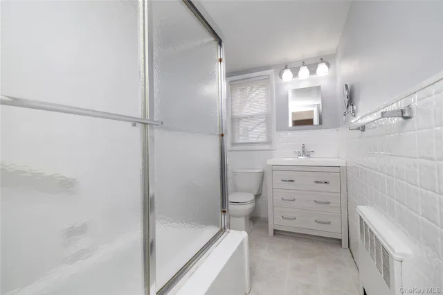 a bathroom with a double vanity sink a mirror and a bathtub