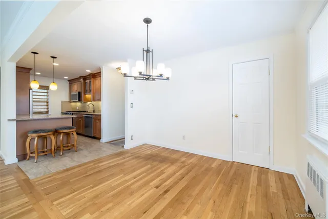 a view of a kitchen with furniture and wooden floor