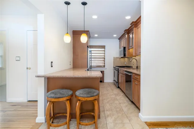 a view of a kitchen with a dining table and chairs