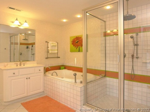 550 Tilghman Road Coats, NC 27521 - Photo 4 of 27 a bathroom with a tub sink shower and mirror