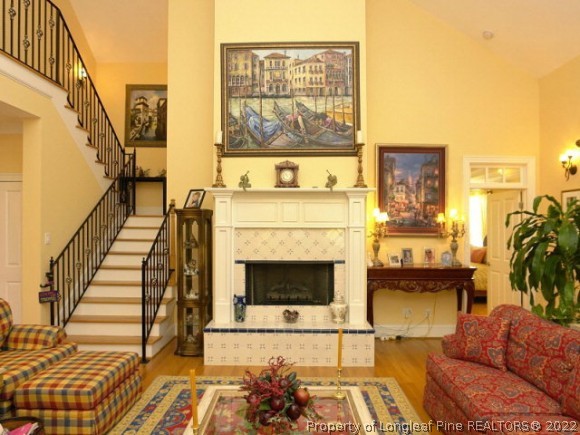 550 Tilghman Road Coats, NC 27521 - Photo 10 of 27 a living room with furniture a flat screen tv and a fireplace