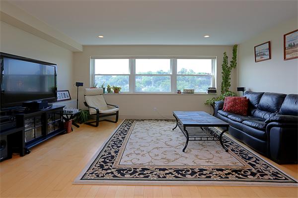 1600 Beacon Street, Unit 1002 Brookline, MA 02446 - Photo 3 of 7 a living room with furniture and a flat screen tv