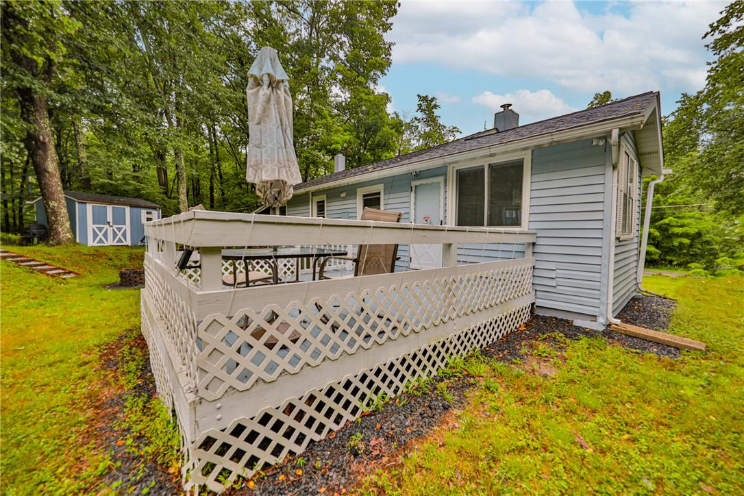 5599 Minks Pond Road Bushkill, PA 18324 - Photo 45 of 64 A tranquil backyard setting with a spacious deck and secluded shed.