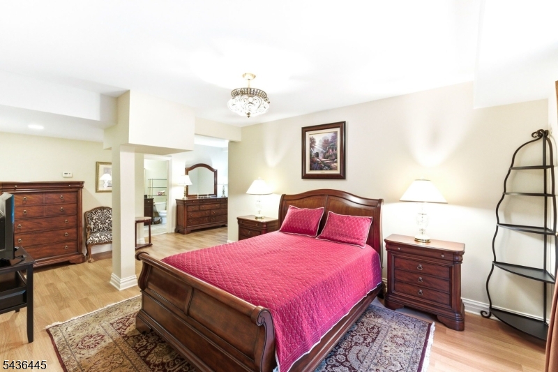 4 Windemere Way Sparta, NJ 07871 - Photo 35 of 50 a bedroom with a bed and dresser with mirror