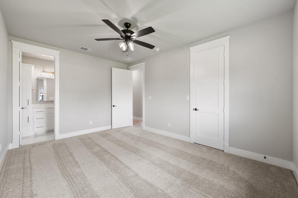 6610 Waggoner Way Midlothian, TX 76065 - Photo 32 of 40 Spacious bedroom featuring light neutral wall paint and plush carpeting