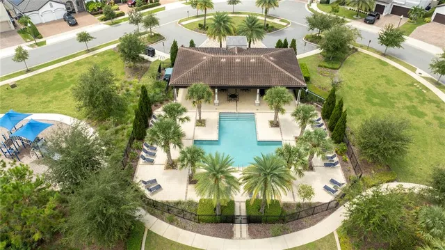 a sign that is sitting in front of a house with a garden