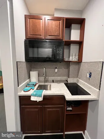 a bedroom with a bed lamp and a potted plant