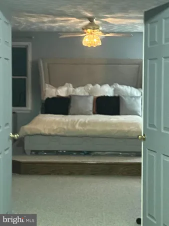 a view of a livingroom with an empty space and a kitchen