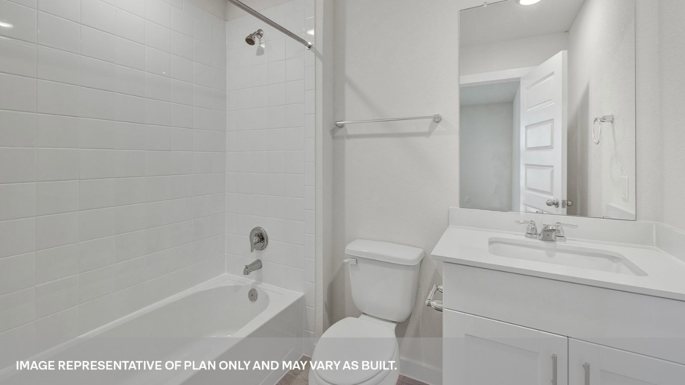 198 Kolbo Crossing Lockhart, TX 78644 - Photo 13 of 23 a bathroom with a sink a toilet and a bathtub