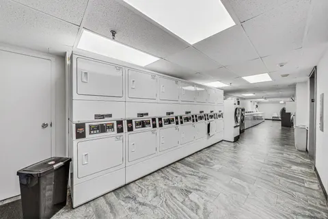 a view of a kitchen with furniture and wooden floor