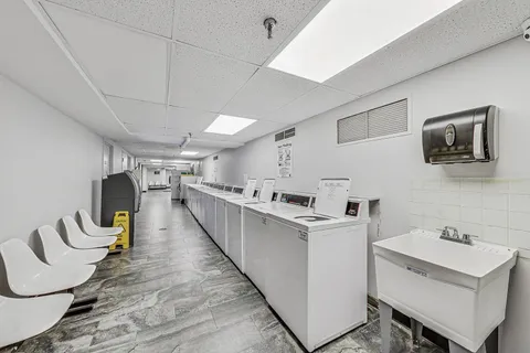 a picture of a room with a bench and white walls