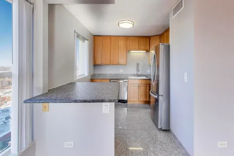 a kitchen with a refrigerator a sink and a cabinets