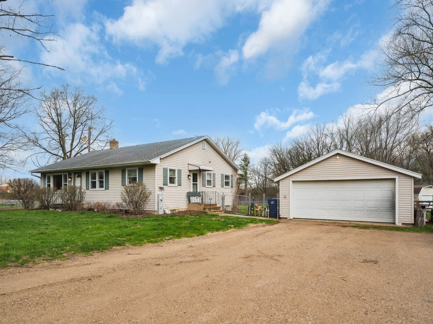 12216 Pleasant Valley Road Woodstock, IL 60098 - Photo 20 of 48 a front view of a house with a garden and trees