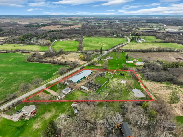 an aerial view of a houses with a yard