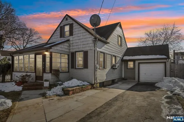 a front view of a house with parking space