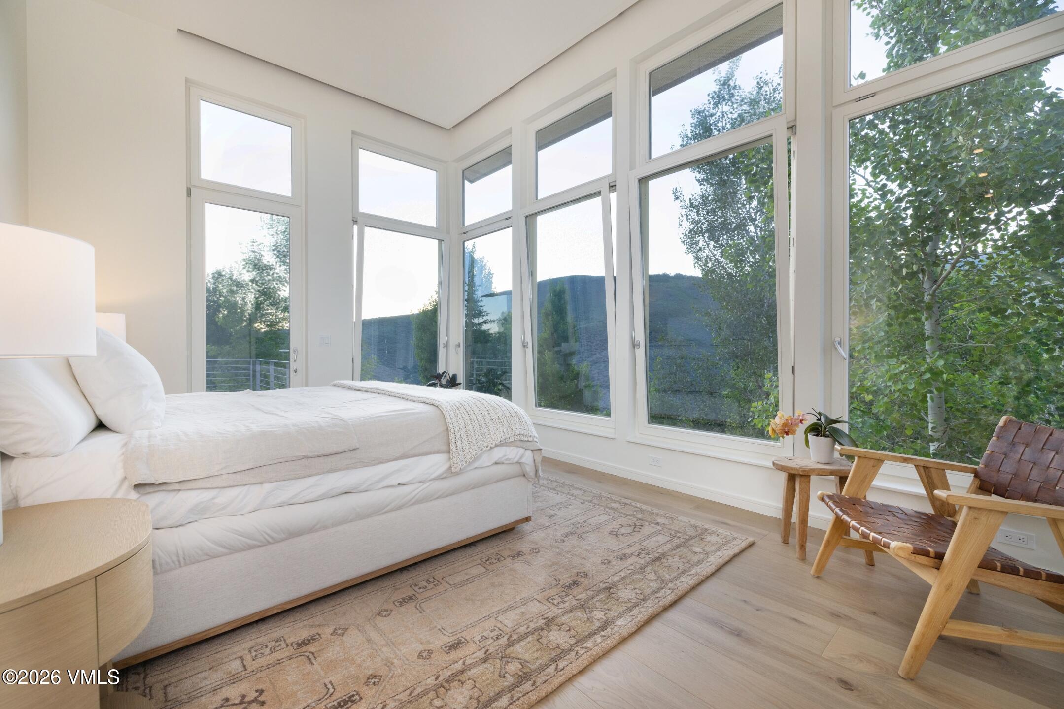 4340 June Point Avon, CO 81620 - Photo 15 of 43 a bed sitting in a bedroom next to a large window