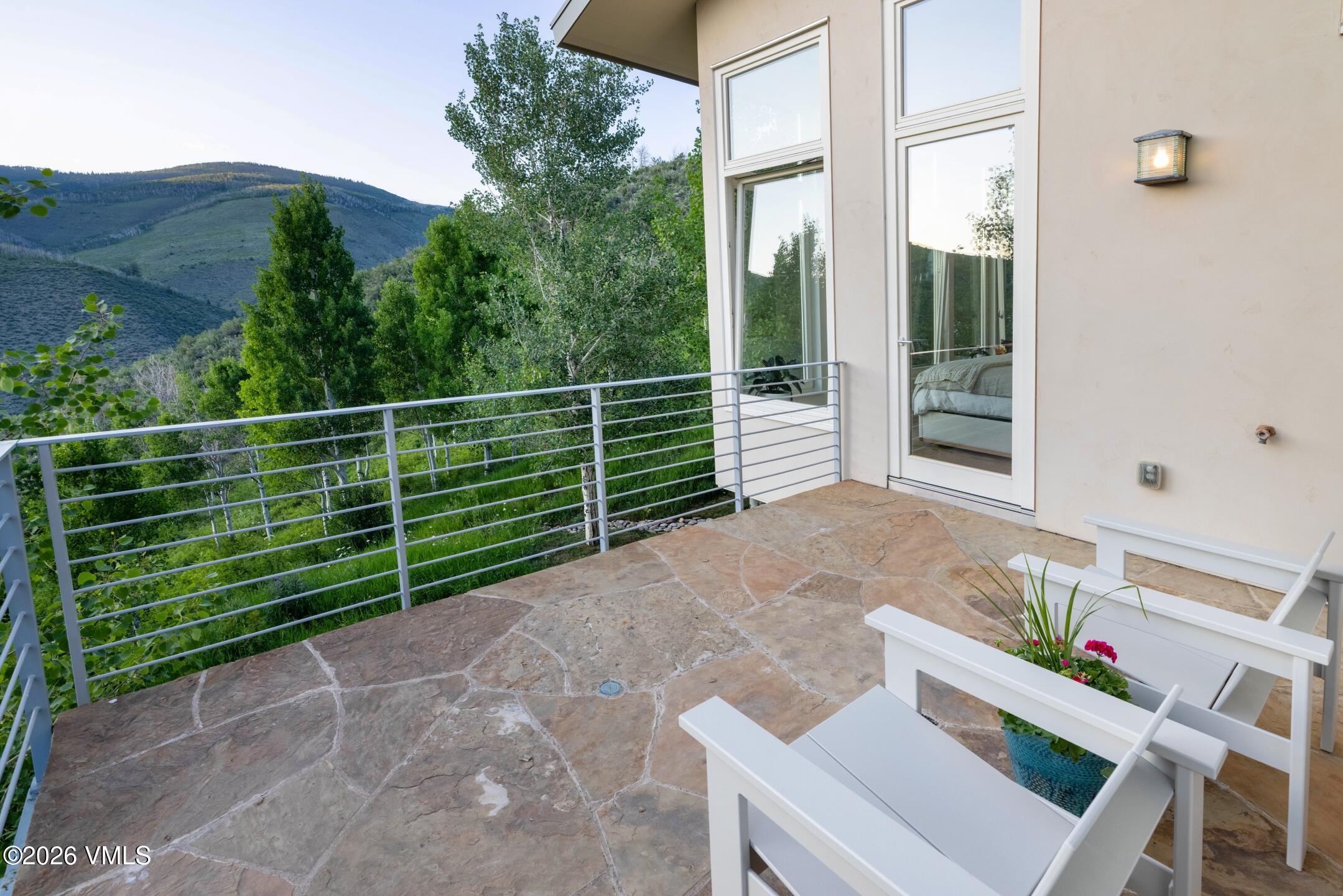 4340 June Point Avon, CO 81620 - Photo 17 of 43 a view of a deck with a table and chairs and potted plants