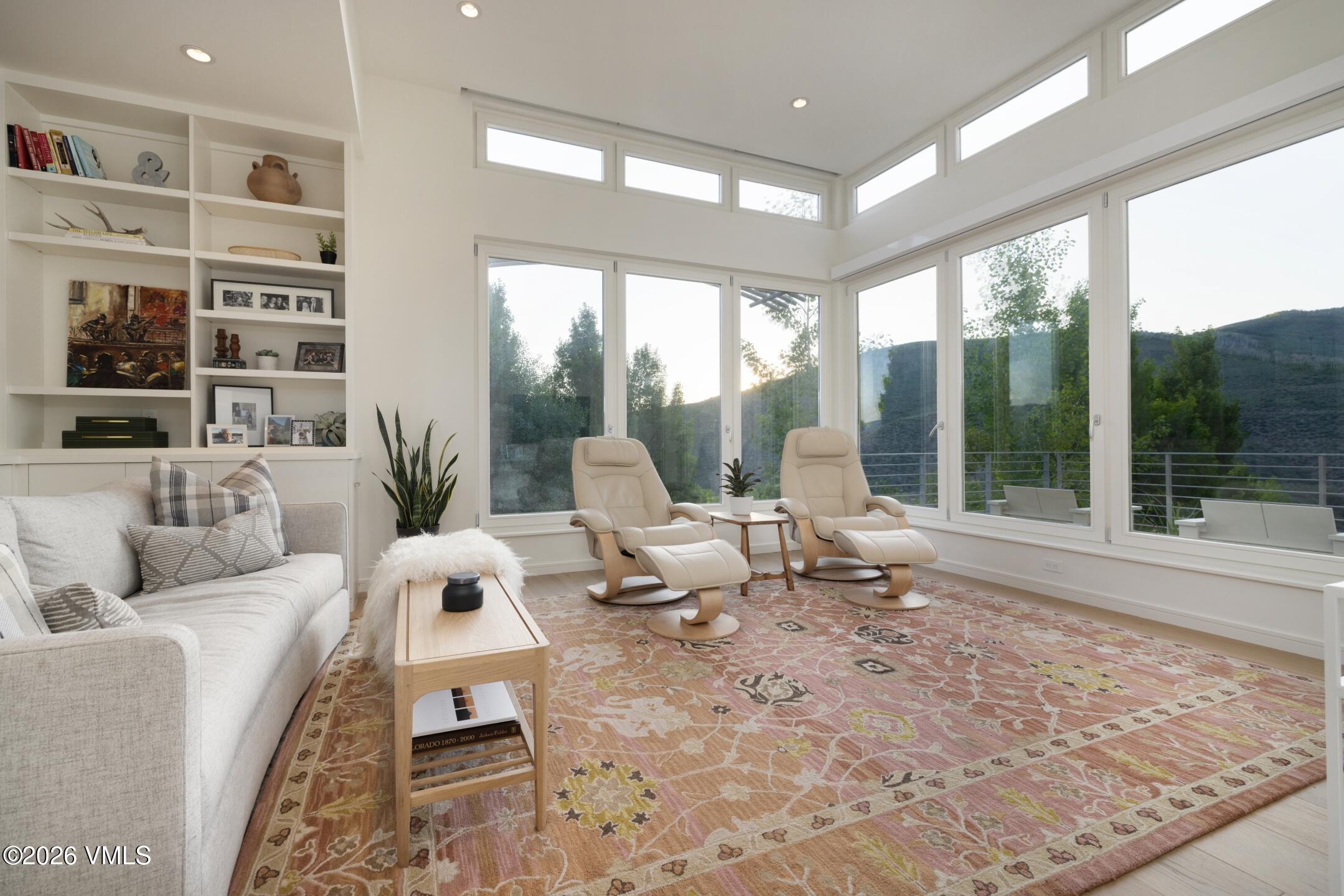 4340 June Point Avon, CO 81620 - Photo 19 of 43 a living room with furniture and floor to ceiling windows