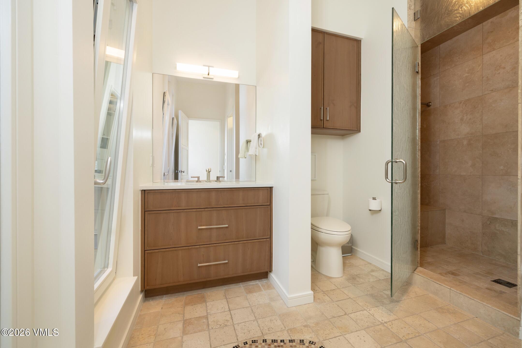 4340 June Point Avon, CO 81620 - Photo 21 of 43 a bathroom with a toilet a sink and mirror