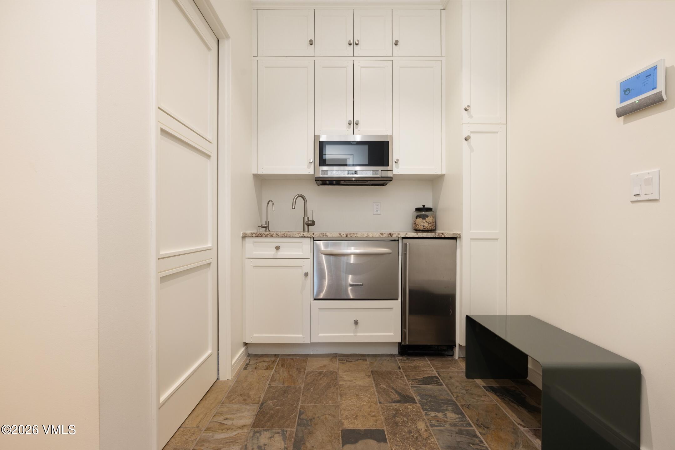 4340 June Point Avon, CO 81620 - Photo 23 of 43 a utility room with cabinets washer and dryer