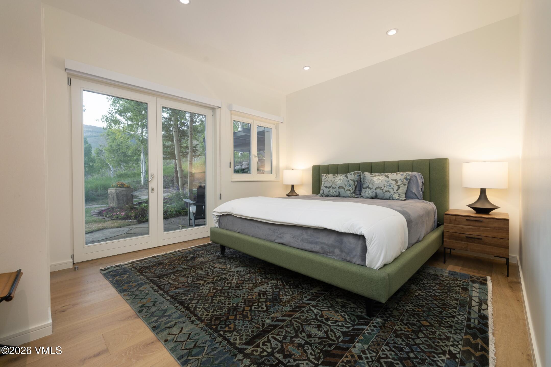 4340 June Point Avon, CO 81620 - Photo 24 of 43 a bedroom with a bed and wooden floor