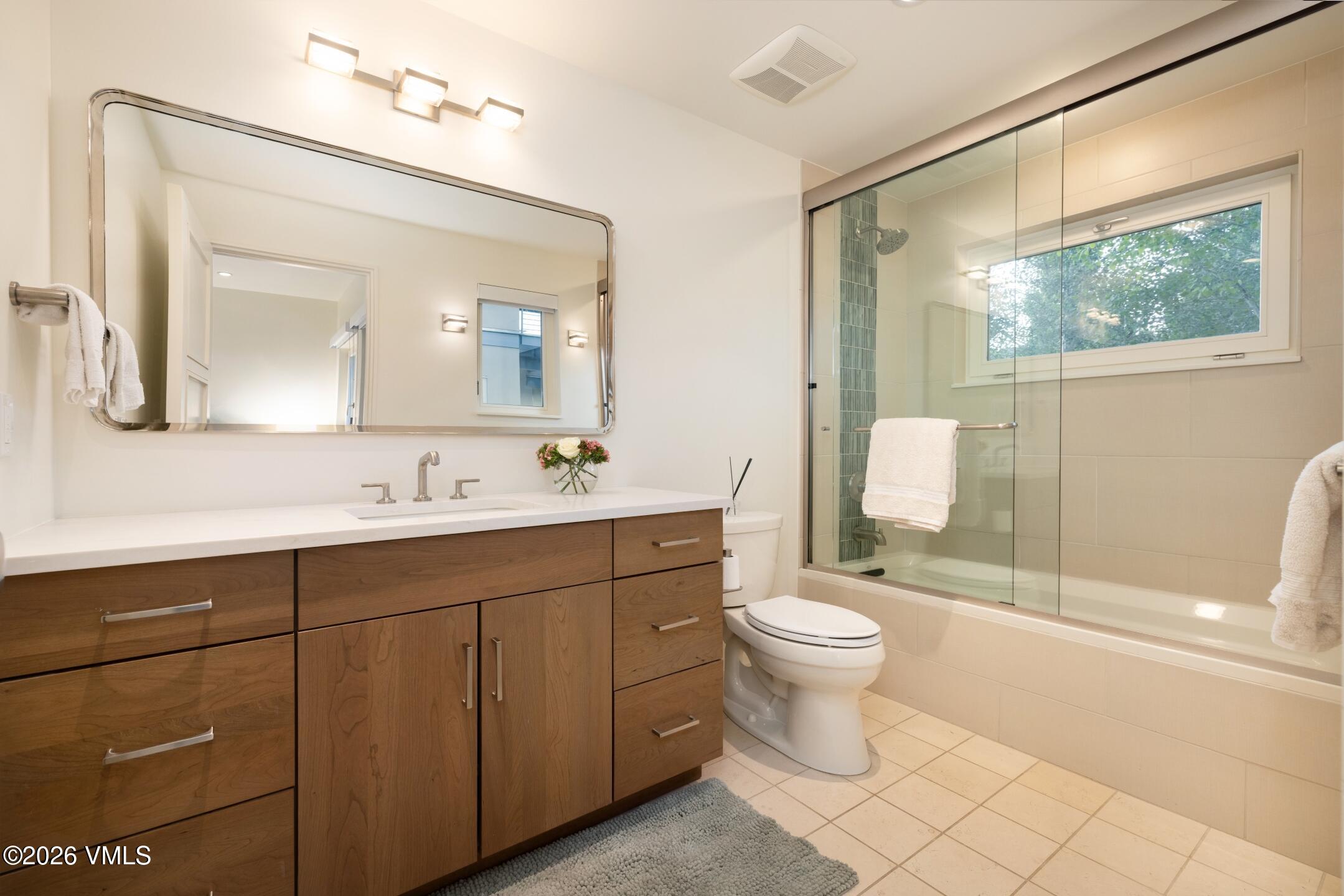 4340 June Point Avon, CO 81620 - Photo 25 of 43 a bathroom with a toilet sink and mirror