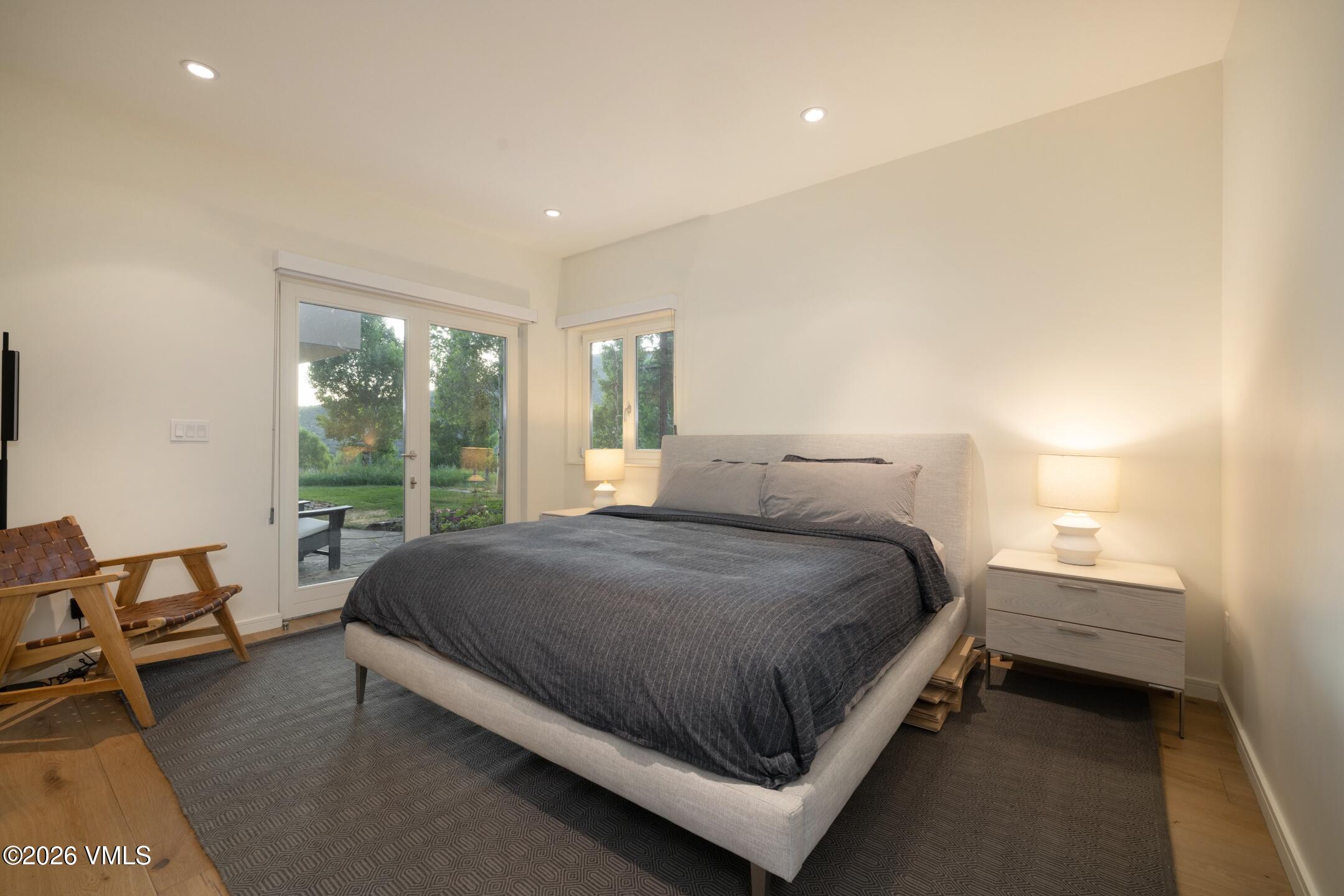 4340 June Point Avon, CO 81620 - Photo 26 of 43 a spacious bedroom with a bed and glass window