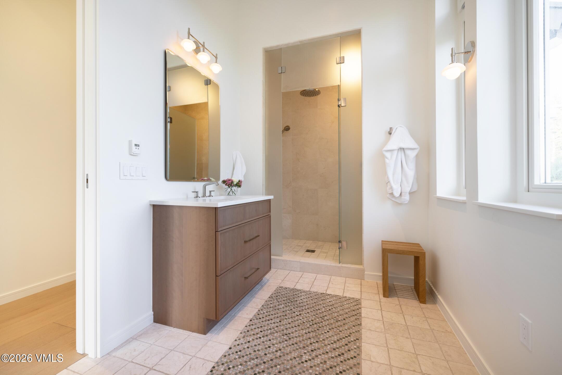 4340 June Point Avon, CO 81620 - Photo 30 of 43 a bathroom with a sink a mirror and a shower