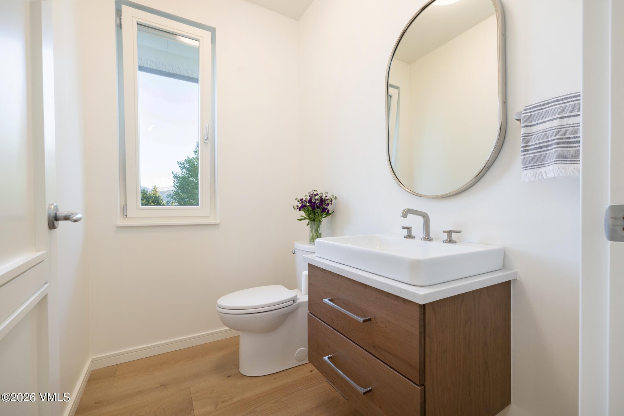 4340 June Point Avon, CO 81620 - Photo 31 of 43 a bathroom with a sink a toilet and a mirror