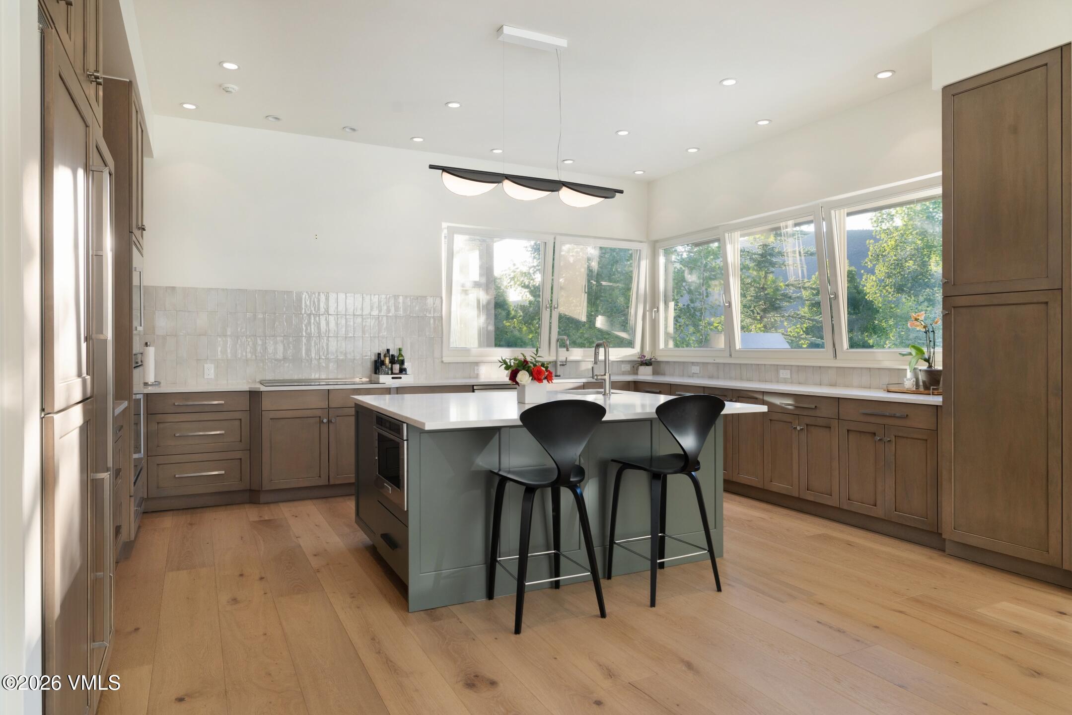 4340 June Point Avon, CO 81620 - Photo 7 of 43 a kitchen with a sink dining table chairs and a large window