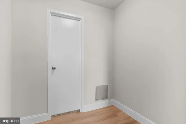 a view of an empty room and wooden floor