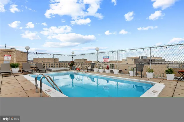 a bathroom with a glass door shower and a sink