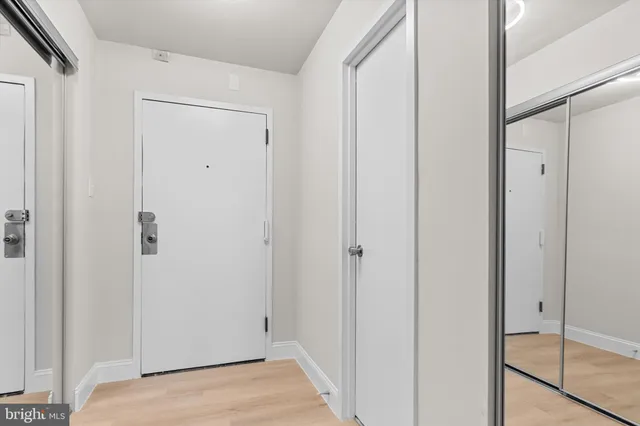 a view of empty room with wooden floor