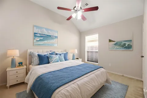 a bedroom with a large bed and a chandelier