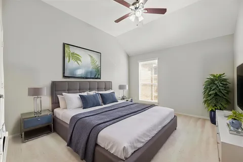 a bedroom with a bed and a potted plant