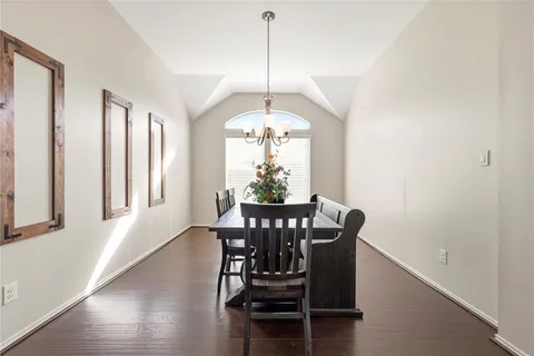 a dining room with furniture window and wooden floor