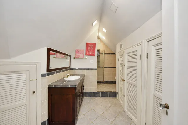 a view of a chair and table in backyard of the house