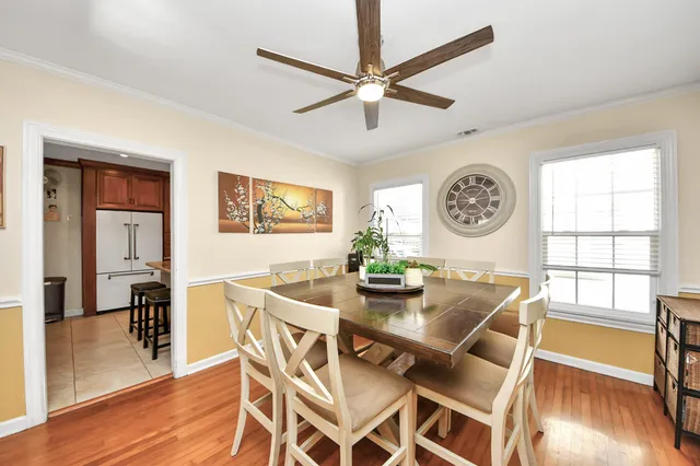 a view of a dining room with furniture and a large window