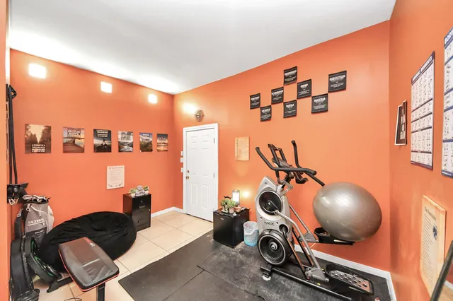 a bedroom with two beds and a desk