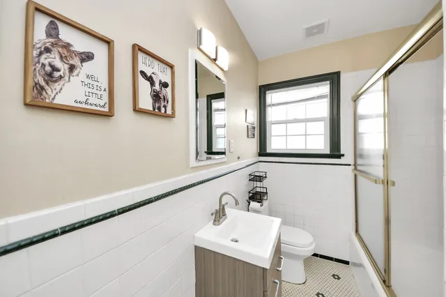 a bathroom with a toilet sink and mirror