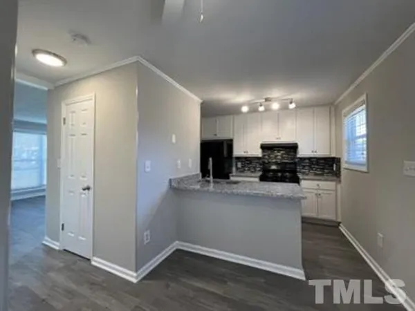 a kitchen with a sink stove and refrigerator