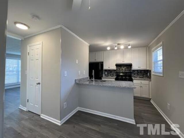 9 Hayti Lane, Unit 9 Durham, NC 27701 - Photo 11 of 25 a kitchen with stainless steel appliances a refrigerator and a stove top oven