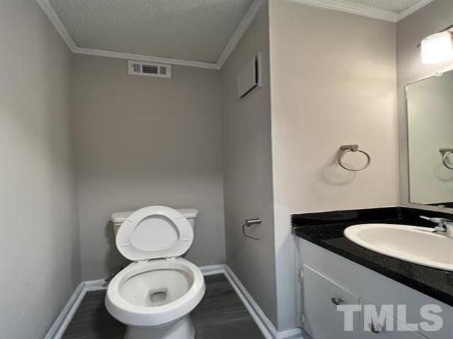 9 Hayti Lane, Unit 9 Durham, NC 27701 - Photo 14 of 25 a bathroom with a toilet sink and mirror