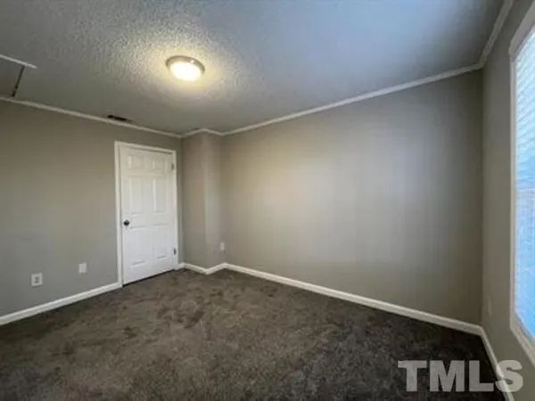 an empty room with a empty space and windows